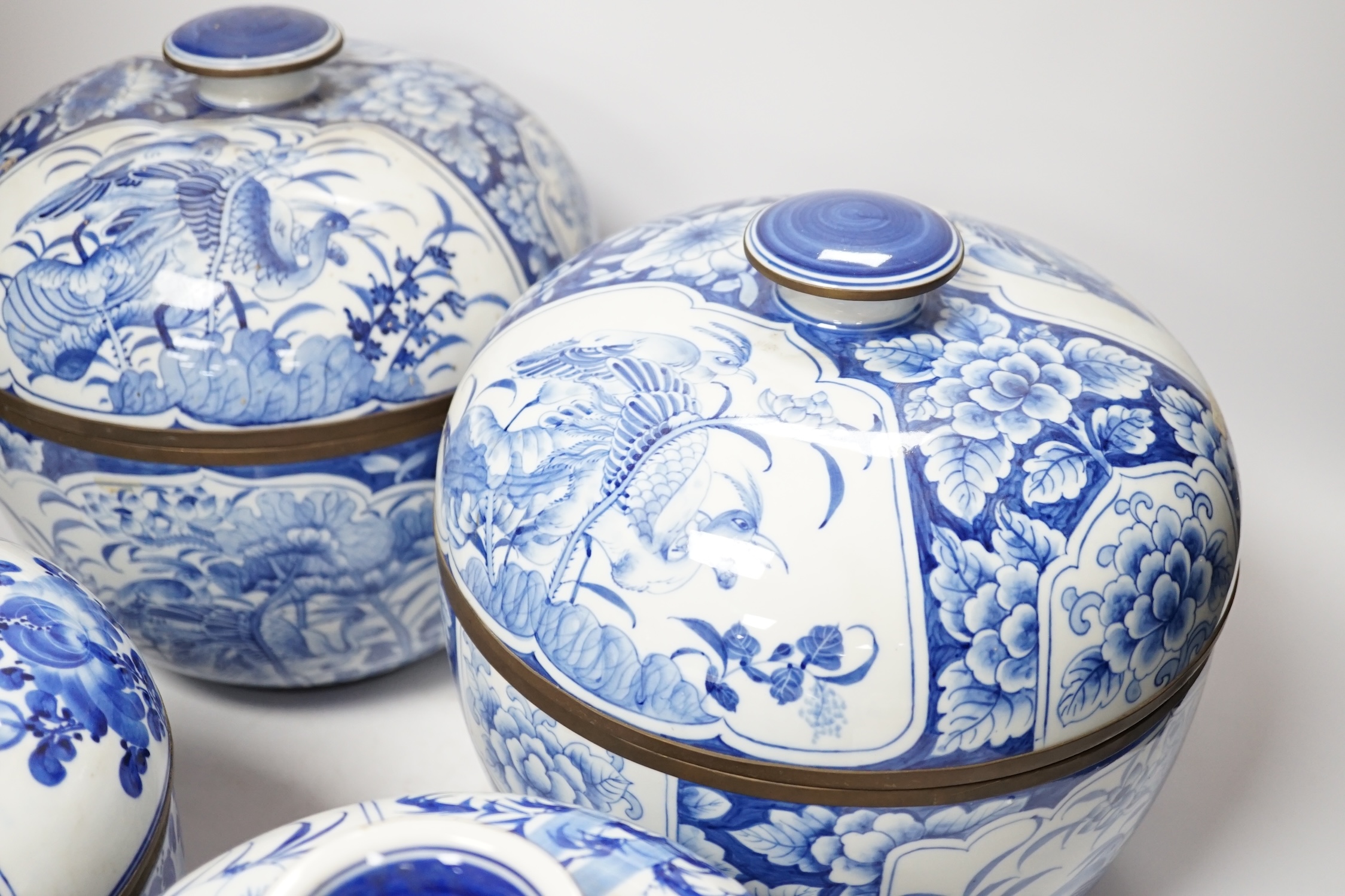 Two pairs of Japanese Arita blue and white bowls and covers, largest 27cm